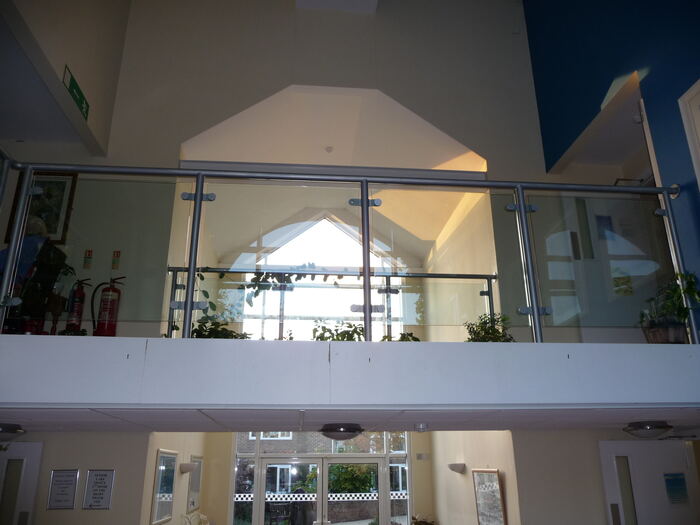 Priory Court — Finished atrium with glass balustrade